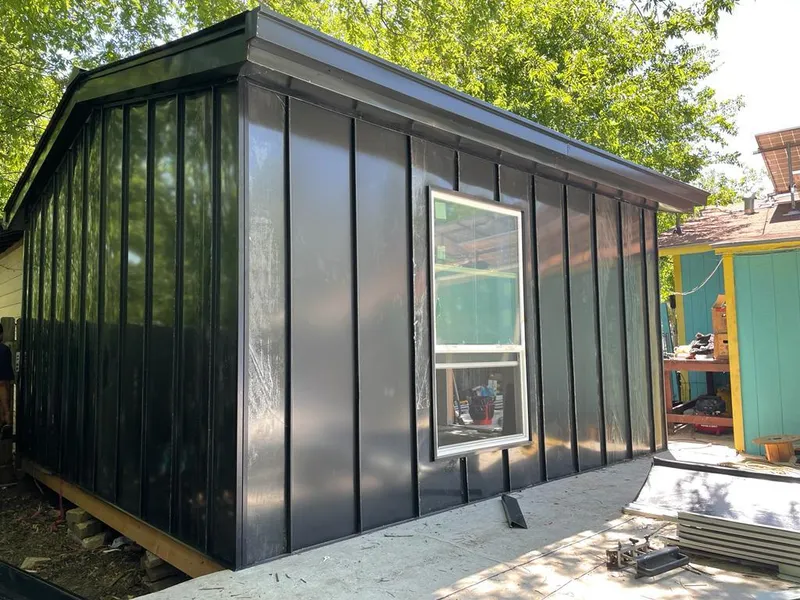 Black standing seam metal wall panels for Roof Inspection in Haslet