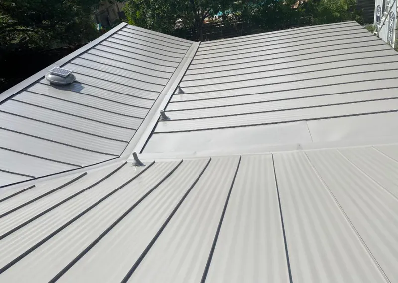 Solar attic fan installed on a metal roof for Roof Ventilation in Haslet